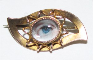 A lady’s blue eye painted in miniature on ivory, in a gold eye-shaped setting. ½” x ¾” Early 19th century. 