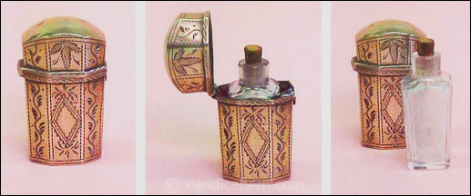Figure 5: Sterling case (1 3/4" tall) made by Joseph Taylor, Birmingham. Interior lined in red velvet. Cut glass bottle (1 1/2" tall) with cork stopper. Hallmarked 1801.